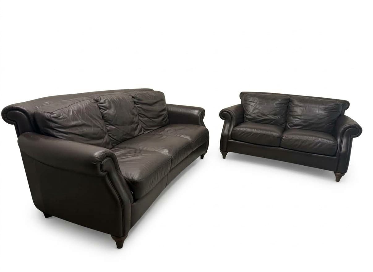 Natuzzi Italian leather sofa and loveseat set in dark brown on white background